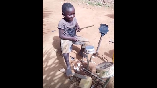 The image shows African kid playing makeshift drums beautifully. (Instagram/@james_tang_123)