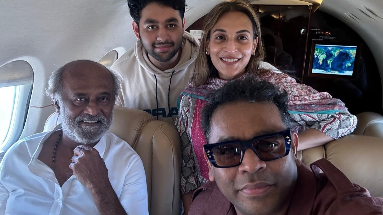 Rajinikanth poses with AR Rahman and daughter Aishwaryaa for selfie inside private jet. See pics