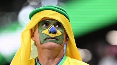 (FILES) In this file photo, A supporter of Brazil waits on the stands ahead of the World Cup quarter-final football match between Croatia and Brazil (AFP) (FILES) In this file photo, A supporter of Brazil waits on the stands ahead of the World Cup quarter-final football match between Croatia and Brazil (AFP)