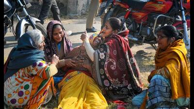 Family members of the victims after a fire broke out in a factory at Fazalganj industrial area, in Kanpur, Friday. (PTI Photo)