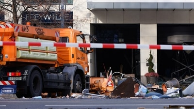 Emergency services work on a street outside a hotel after a burst and leak of the AquaDom aquarium. (REUTERS)