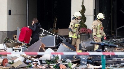 Emergency services work on a street outside a hotel after a burst and leak of the AquaDom aquarium in central Berlin near Alexander platz, with water poured out onto the street. (REUTERS)