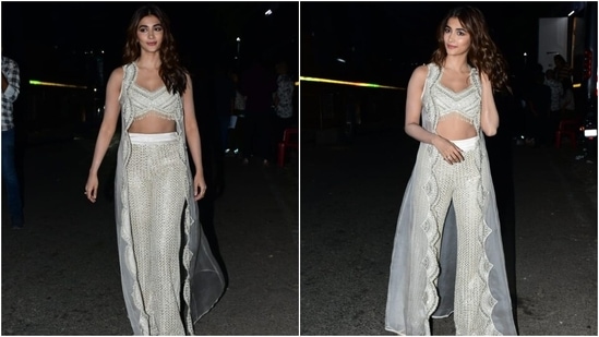 Pooja's ensemble for the promotional event features a sleeveless bralette-style blouse. It comes with a plunging V neckline, intricate silver gota patti embroidery, tassel embellishments on the asymmetric hem, sequin and thread work, a fitted bust, and cropped midriff-baring silhouette.&nbsp;(Instagram)