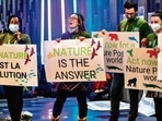 Climate activists hold signs during the United the Nations Biodiversity Conference (COP15) in Canada’s Montreal. (AFP) Climate activists hold signs during the United the Nations Biodiversity Conference (COP15) in Canada’s Montreal. (AFP)