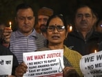 Asha Devi (C), mother of the 2012 Delhi gang rape victim, along with people hold candles and placards during a vigil on the tenth anniversary of the heinous gang rape of a young woman in Delhi on December 16.(AFP) Asha Devi (C), mother of the 2012 Delhi gang rape victim, along with people hold candles and placards during a vigil on the tenth anniversary of the heinous gang rape of a young woman in Delhi on December 16.(AFP)