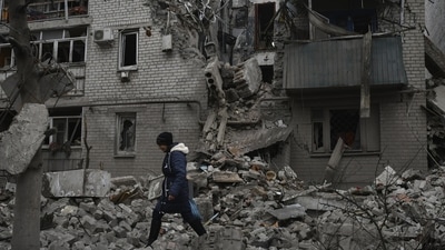 A woman walks past debris of the destroyed house after Russian air strike in Ukraine. (AP/ Representative Image) A woman walks past debris of the destroyed house after Russian air strike in Ukraine. (AP/ Representative Image)