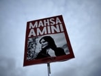 Iran anti-Hijab protest: A woman holds a placard with a picture of Iranian woman Mahsa Amini, who died in custody.