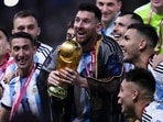Argentina's Lionel Messi and teammates celebrate with the World Cup trophy after Argentina defeated France in the World Cup final 2022 Argentina's Lionel Messi and teammates celebrate with the World Cup trophy after Argentina defeated France in the World Cup final 2022