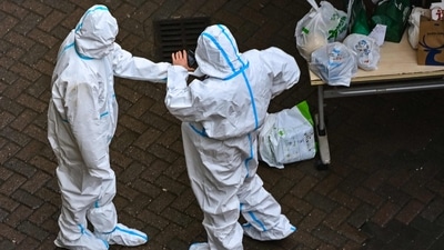 Covid In China: Security guards at the entrance of a compound under Covid-19 lockdown in the Jing'an district in Shanghai. (AFP) Covid In China: Security guards at the entrance of a compound under Covid-19 lockdown in the Jing'an district in Shanghai. (AFP)