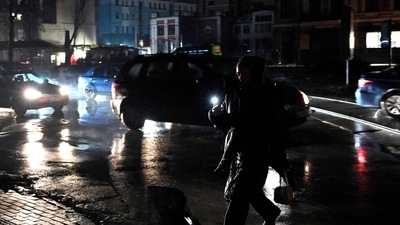 Russia-Ukraine War: A woman uses a flashlight as she crosses a street during a blackout following Russian strikes on the power infrastructure in Kyiv. (AFP) Russia-Ukraine War: A woman uses a flashlight as she crosses a street during a blackout following Russian strikes on the power infrastructure in Kyiv. (AFP)