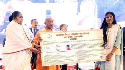 Uttar Pradesh chief minister Yodi Adityanath distributing appointment letters to assistant teachers selected by UPPSC under ‘Mission Rozgar’, in Lucknow on Sunday (ANI PHOTO)