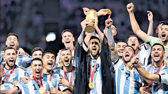 Lionel Messi Kisses His Trophy While Celebrating Win at FIFA World