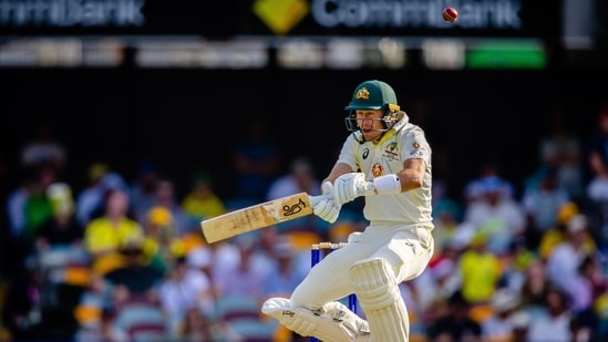 Marnus Labuschagne ducks under a rising delivery from Anrich Nortje at the Gabba, in Brisbane(AFP)