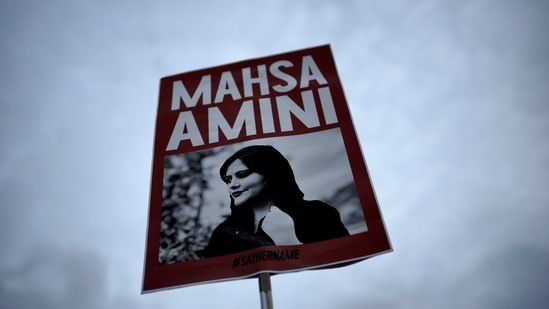 Iran anti-Hijab protest: A woman holds a placard with a picture of Iranian woman Mahsa Amini, who died in custody.(AP/Representational image)