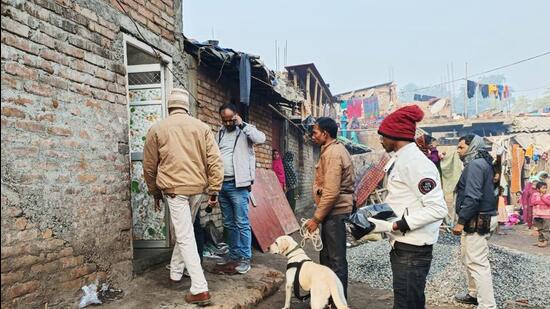 Police personnel along with a sniffer dog inspect the house of the accused identified as Dildar Ansari who allegedly killed his wife, in Sahibganj on Sunday. (Agencies)