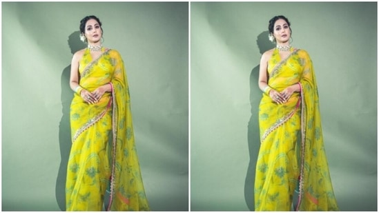 Hina decked up in the yellow chiffon saree featuring pink and silver zari borders. The saree also came with floral patterns in pastel green and silver.&nbsp;(Instagram/@realhinakhan)