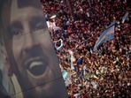 Argentina fans celebrate winning the World Cup at the Obelisk on Sunday, December 18, with an image of the captain Lionel Messi. Fireworks cracked, car horns sounded and fans draped in the national blue and white colors sang, danced, and waved flags.  (Agustin Marcarian / REUTERS)