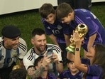 Argentina's Lionel Messi takes pictures of his wife Antonela Roccuzzo as she holds the winners trophy after Argentina won the FIFA World Cup final soccer match against France at the Lusail Stadium.(AP) Argentina's Lionel Messi takes pictures of his wife Antonela Roccuzzo as she holds the winners trophy after Argentina won the FIFA World Cup final soccer match against France at the Lusail Stadium.(AP)