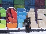 Delegates take souvenir photos during a snowfall outside the convention centre at the COP15 UN conference on biodiversity in Montreal, on Friday. (AP) Delegates take souvenir photos during a snowfall outside the convention centre at the COP15 UN conference on biodiversity in Montreal, on Friday. (AP)