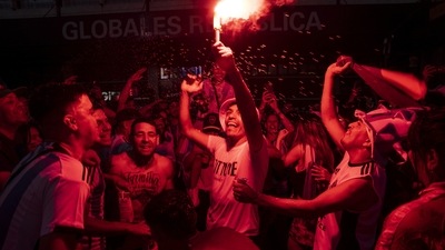 Soccer fans light a flare celebrating their team's World Cup victory over France in Buenos Aires, on Sunday, December 18. “We're champions, which is all we wanted, more than anything for (Messi) and for the whole team,” Santiago Ferraris, 25, said. (Rodrigo Abd / AP ) Soccer fans light a flare celebrating their team's World Cup victory over France in Buenos Aires, on Sunday, December 18. “We're champions, which is all we wanted, more than anything for (Messi) and for the whole team,” Santiago Ferraris, 25, said. (Rodrigo Abd / AP )