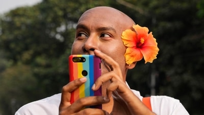 A participant takes photographs from his mobile during the pride walk. (AP) A participant takes photographs from his mobile during the pride walk. (AP)