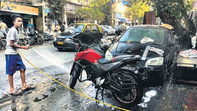 Mumbai, India - December 19, 2022: Bike washing on the roadside, at Grant Road, in Mumbai, India, on Monday, December 19, 2022. (Photo by Bhushan Koyande/HT Photo) (HT PHOTO) Mumbai, India - December 19, 2022: Bike washing on the roadside, at Grant Road, in Mumbai, India, on Monday, December 19, 2022. (Photo by Bhushan Koyande/HT Photo) (HT PHOTO)