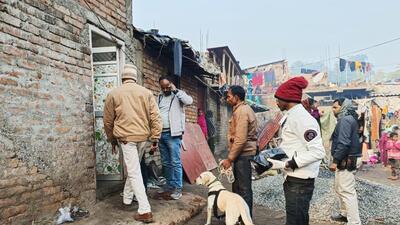 Police personnel along with a sniffer dog inspect the house of the accused Dildar Ansari who allegedly killed his wife by cutting her into at least 12 pieces, in Sahibganj on Sunday. (Agencies) Police personnel along with a sniffer dog inspect the house of the accused Dildar Ansari who allegedly killed his wife by cutting her into at least 12 pieces, in Sahibganj on Sunday. (Agencies)