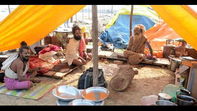 Seers sitting under a plastic sheet overseeing setting up of their camps at the tent city coming up for Magh Mela. (HT photo) Seers sitting under a plastic sheet overseeing setting up of their camps at the tent city coming up for Magh Mela. (HT photo)