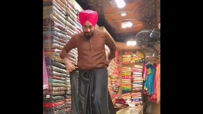 The image, taken from the Twitter video, shows the shopkeeper's saree draping skills. (Twitter/@PunjabiTouch)