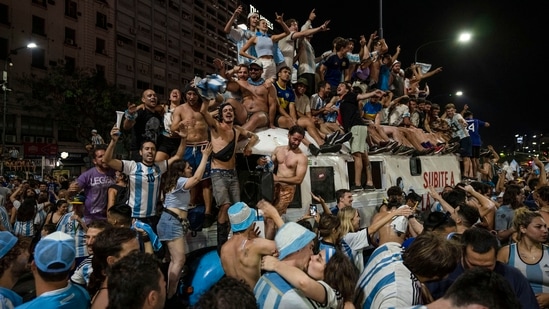 Soccer fans celebrate Argentina's victory over France in the World Cup final soccer match, in Buenos Aires, Argentina, on Sunday. "This is happiness for everyone, for all these people. Today it was our turn and the joy is ours," hotel receptionist Julio Berdun told AFP at the capital's Plaza de Mayo square. (AP)