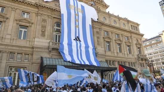 A giant jersey of the Argentine national soccer team hung on the front of the Colon Theater as fans celebrate their team's World Cup victory over France in Buenos Aires, Argentina, Sunday. (Gustavo Garello / AP )
