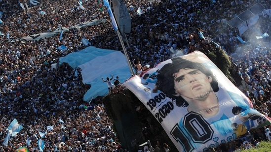 Argentina fans with a Diego Maradona banner celebrate after winning the World Cup by the Obelisco, on Sunday, December 18. Messi finally crowned his record-breaking career with the one trophy that was missing as he produced a performance that will go down in World Cup history. “Holding Leo Messi by the hand, we're going to go all the way,” the crowd chanted as euphoria took over. (Agustin Marcarian / REUTERS)