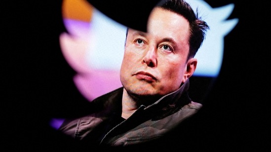 Elon Musk's photo is seen through a Twitter logo in this illustration. (REUTERS)