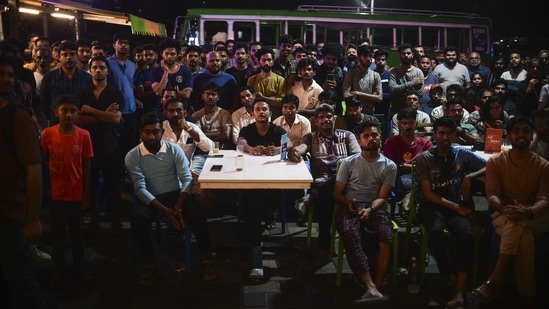 People at a restaurant in Kochi watch the World Cup final on television.(AP)
