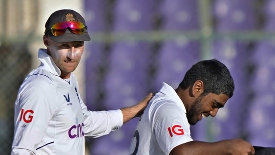 England's Rehan Ahmed, right, is congratulated by teammate Joe Root(AP)