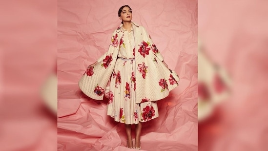 Sonam Kapoor opted for a maxi-length dress featuring a flared hemline, red flowers all over her white dress and a sleek belt. The neckline came decorated with white lace that added extra grace to her outfit. (Instagram/@sonamkapoor)