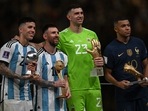 Argentina's captain and forward #10 Lionel Messi (2ndL) and France's forward #10 Kylian Mbappe (R) pose on stage with Argentina's midfielder #24 Enzo Fernandez (L) and Argentina's goalkeeper #23 Emiliano Martinez after being respectively awarded with Golden Ball and Boot, Best Young PLayer and Golden Glove player during the trophy ceremony after Argentina won the Qatar 2022 World Cup final football match between Argentina and France at Lusail Stadium in Lusail, north of Doha on December 18, 2022. (Photo by Paul ELLIS / AFP)(AFP) Argentina's captain and forward #10 Lionel Messi (2ndL) and France's forward #10 Kylian Mbappe (R) pose on stage with Argentina's midfielder #24 Enzo Fernandez (L) and Argentina's goalkeeper #23 Emiliano Martinez after being respectively awarded with Golden Ball and Boot, Best Young PLayer and Golden Glove player during the trophy ceremony after Argentina won the Qatar 2022 World Cup final football match between Argentina and France at Lusail Stadium in Lusail, north of Doha on December 18, 2022. (Photo by Paul ELLIS / AFP)(AFP)