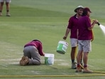 Ground staff work on the wicket following the first cricket test between South Africa and Australia at the Gabba in Brisbane, Australia, Sunday, Dec.18, 2022.Australia defeated South Africa by six wickets. (AP Photo/Tertius Pickard)