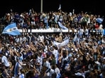 A huge crowd welcomes the Argentina football team.