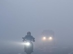 Vehicles move slowly amid low visibility due to fog on a cold winter morning, at NH24 near Akshardham Temple in New Delhi on Monday. (Raj K Raj/HT Photo) Vehicles move slowly amid low visibility due to fog on a cold winter morning, at NH24 near Akshardham Temple in New Delhi on Monday. (Raj K Raj/HT Photo)