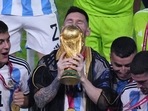 Argentina's Lionel Messi kisses the trophy as he celebrates with his teammates at the end of the World Cup final Argentina's Lionel Messi kisses the trophy as he celebrates with his teammates at the end of the World Cup final
