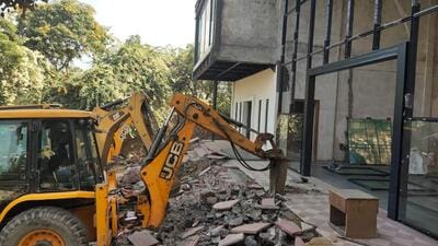 A JCB machine demolishes a farmhouse in Gwal Pahari village on the Gurugram-Faridabad road on Tuesday. (Parveen Kumar/HT Photo) A JCB machine demolishes a farmhouse in Gwal Pahari village on the Gurugram-Faridabad road on Tuesday. (Parveen Kumar/HT Photo)