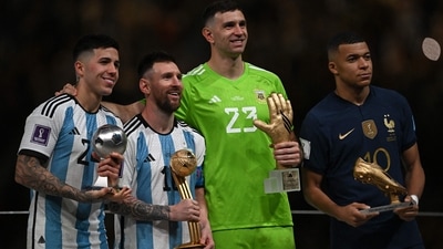 Argentina's captain and forward #10 Lionel Messi (2ndL) and France's forward #10 Kylian Mbappe (R) pose on stage with Argentina's midfielder #24 Enzo Fernandez (L) and Argentina's goalkeeper #23 Emiliano Martinez after being respectively awarded with Golden Ball and Boot, Best Young PLayer and Golden Glove player during the trophy ceremony after Argentina won the Qatar 2022 World Cup final football match between Argentina and France at Lusail Stadium in Lusail, north of Doha on December 18, 2022. (Photo by Paul ELLIS / AFP) (AFP) Argentina's captain and forward #10 Lionel Messi (2ndL) and France's forward #10 Kylian Mbappe (R) pose on stage with Argentina's midfielder #24 Enzo Fernandez (L) and Argentina's goalkeeper #23 Emiliano Martinez after being respectively awarded with Golden Ball and Boot, Best Young PLayer and Golden Glove player during the trophy ceremony after Argentina won the Qatar 2022 World Cup final football match between Argentina and France at Lusail Stadium in Lusail, north of Doha on December 18, 2022. (Photo by Paul ELLIS / AFP) (AFP)