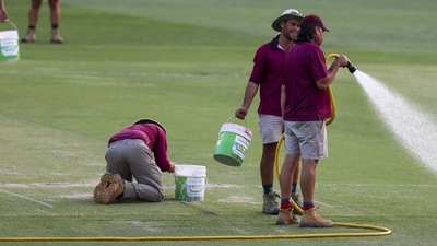 Ground staff work on the wicket following the first cricket test between South Africa and Australia at the Gabba in Brisbane, Australia, Sunday, Dec.18, 2022.Australia defeated South Africa by six wickets. (AP Photo/Tertius Pickard) (AP)