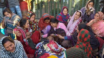 Family members and relatives mourn near the body of a local youth who was killed in alleged firing by sentry of an army camp, in Rajouri. (PTI)