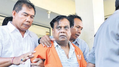 Police escort Indian gangster Rajendra Nikalje, widely known as Chhota Rajan, at police headquarters in Denpasar, Bali November 2, 2015 in this photo taken by Antara Foto. Indonesia will deport one of India's most wanted men on Tuesday to face charges in more than two dozen murder cases at home. Rajendra Nikalje was arrested by police on Indonesia's resort island of Bali last week, ending a two-decade-long international manhunt. Rajan has been on Interpol's wanted list since 1995 suspected of running a crime syndicate that engaged in extortion, arms struggling and contract killing. Picture taken November 2, 2015. REUTERS/Nyoman Budhiana/Antara Foto ATTENTION EDITORS - THIS IMAGE HAS BEEN SUPPLIED BY A THIRD PARTY. IT IS DISTRIBUTED, EXACTLY AS RECEIVED BY REUTERS, AS A SERVICE TO CLIENTS. FOR EDITORIAL USE ONLY. NOT FOR SALE FOR MARKETING OR ADVERTISING CAMPAIGNS. MANDATORY CREDIT. INDONESIA OUT. NO COMMERCIAL OR EDITORIAL SALES IN INDONESIA. TPX IMAGES OF THE DAY (REUTERS) Police escort Indian gangster Rajendra Nikalje, widely known as Chhota Rajan, at police headquarters in Denpasar, Bali November 2, 2015 in this photo taken by Antara Foto. Indonesia will deport one of India's most wanted men on Tuesday to face charges in more than two dozen murder cases at home. Rajendra Nikalje was arrested by police on Indonesia's resort island of Bali last week, ending a two-decade-long international manhunt. Rajan has been on Interpol's wanted list since 1995 suspected of running a crime syndicate that engaged in extortion, arms struggling and contract killing. Picture taken November 2, 2015. REUTERS/Nyoman Budhiana/Antara Foto ATTENTION EDITORS - THIS IMAGE HAS BEEN SUPPLIED BY A THIRD PARTY. IT IS DISTRIBUTED, EXACTLY AS RECEIVED BY REUTERS, AS A SERVICE TO CLIENTS. FOR EDITORIAL USE ONLY. NOT FOR SALE FOR MARKETING OR ADVERTISING CAMPAIGNS. MANDATORY CREDIT. INDONESIA OUT. NO COMMERCIAL OR EDITORIAL SALES IN INDONESIA. TPX IMAGES OF THE DAY (REUTERS)