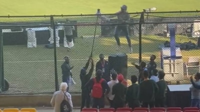 England coach Brendon McCullum climbs up a fence for Pakistan fans England coach Brendon McCullum climbs up a fence for Pakistan fans