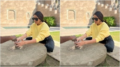 Mrunal posed in a yellow baggy sweatshirt with closed neckline and full sleeves, folded. She further teamed her sweatshirt with a pair of black capris featuring white borders. (Instagram/@mrunalthakur) Mrunal posed in a yellow baggy sweatshirt with closed neckline and full sleeves, folded. She further teamed her sweatshirt with a pair of black capris featuring white borders. (Instagram/@mrunalthakur)