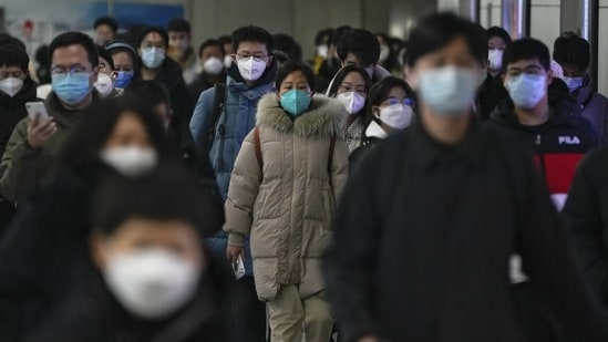 Masked commuters at a subway station during the morning rush hour in Beijing, on December 20. In wake of the Chinese government’s decision to lift the Covid curbs, cases have seen an upward rise across the country, AFP reported.(Andy Wong / AP)