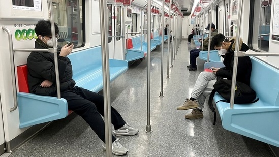 Commuters wearing face masks ride a subway train in Shanghai on December 20. As of December 19, China has officially reported 5,242 Covid-related deaths during the pandemic, a tiny fraction of its 1.4 billion population, Reuters reported.(Casey Hall / REUTERS)